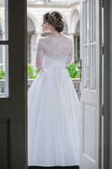 Fototapeta premium Beautiful bride in wedding dress before wedding ceremony