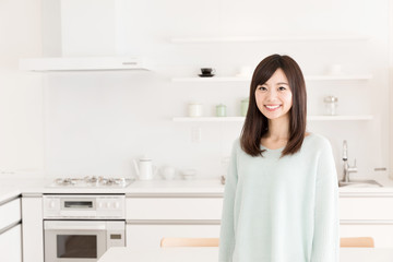 portrait of young asian woman in the kitchen