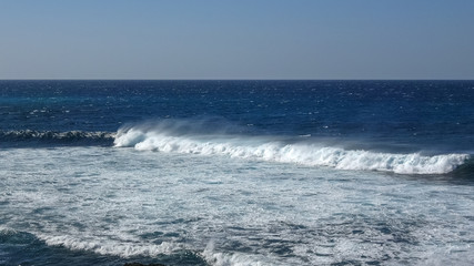 Ocean waves on the black rocky coastline in Canarias