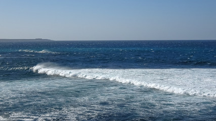 Fototapeta na wymiar Ocean waves on the black rocky coastline in Canarias