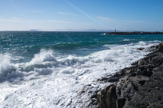 Ocean waves on the black rocky coastline in Canarias