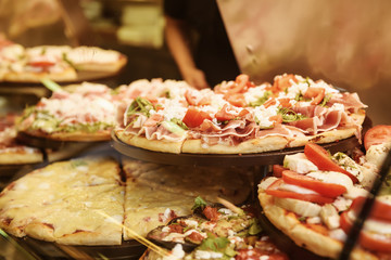 True italian pizza in the showcase of pizzeria in Florence, Italy. Food background.