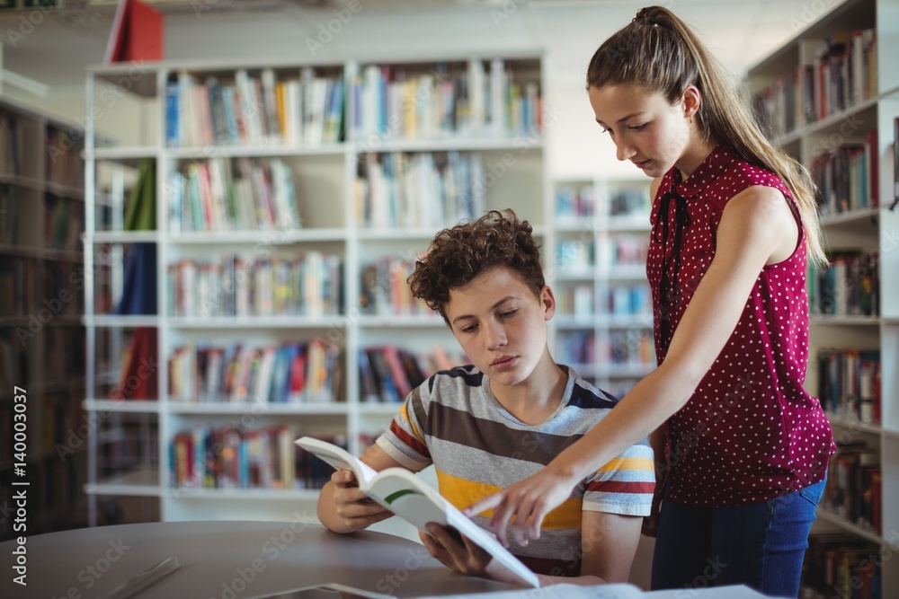 Wall mural classmates reading book in library