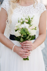 Obraz na płótnie Canvas Bride holding delicate marriage bouquet