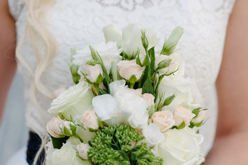 Bride holding delicate marriage bouquet