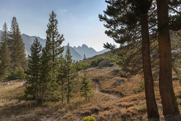 Alpine Mountain Trail - A winding high alpine mountain trail leading to granite mountain in the background on the Pacific Crest Trail. 