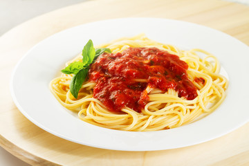 Tasty colorful appetizing cooked spaghetti italian pasta with tomato sauce bolognese and fresh basil. Closeup.