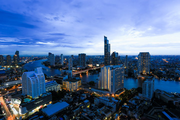 Obraz premium Night light of Bangkok. view light blue background of glass high rise building skyscraper commercial of future. Business concept of success industry tech architecture