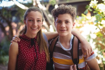 happy classmates standing with arms around