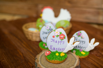 Obraz na płótnie Canvas Colorful easter cookies on wooden background. Festive decoration. Happy Easter.