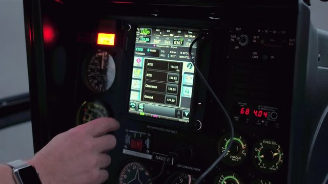 CLOSE UP: A helicopter pilot manipulates the helicopter flight controls to achieve and maintain controlled aerodynamic flight. Pilot adjusting the settings to take off in a chopper and start a journey