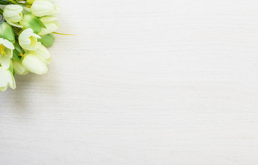Spring tulips lying on white wooden table background
