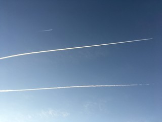 different contrails in clear morning sky