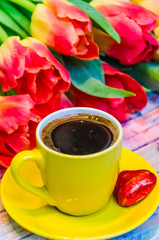Still life with tulips on the wooden background