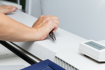 Technician with plotter cleaning tool in office