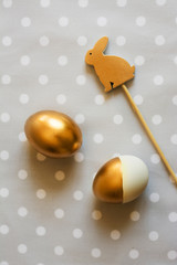 Gold easter eggs and wood rabbit decorated, from above