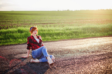 Naklejka na ściany i meble Girl on a green field background