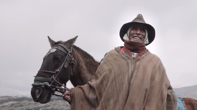 Native quechua man using a chullo and a highlander hat. Peru. Slow motion