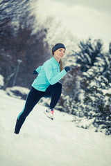 Fototapeta na wymiar Running girl wearing sportswear, winter fitness
