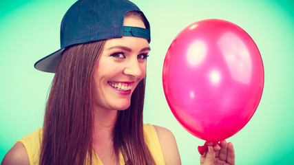 Happy teenage girl with red balloon.