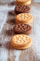Cookies in a row on a wooden white table