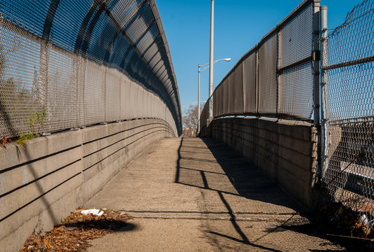 Fototapeta Urban chain link fence walkway. Industrial art and design. Overpass concrete bridge walkway.Black and white. Abstract art and design. Outdoor architectural detail and design. Abstract colors. 