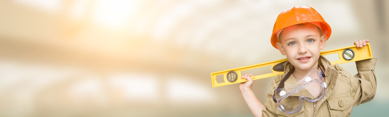Cute Young Boy Dressed As Contractor Holding Level Wide Banner with Room For Text.