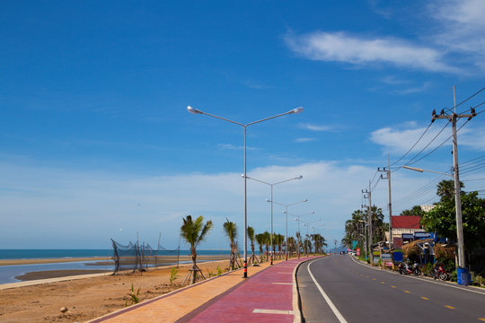 The Restaurants and Seafront road and bike len in day time on Prakash Buri, Prachuap Khiri Khan