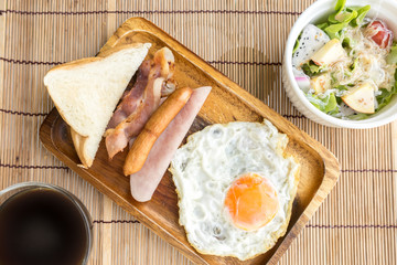 american breakfast beautiful fried egg on wood dish with salad and coffe