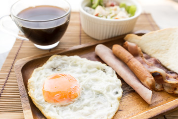 american breakfast beautiful fried egg on wood dish with salad and coffe