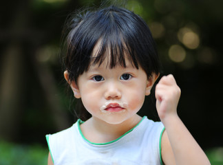 Adorable Little girl eating ice cream