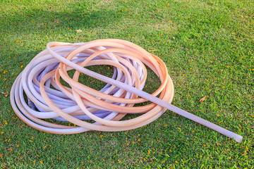 rubber tube on the green grass of garden