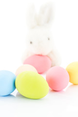 Easter eggs and rabbit on white
