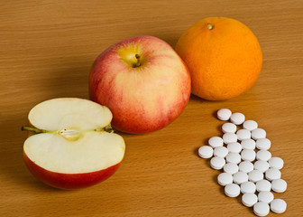 Ripe apples and white pills