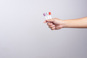 Hand holding empty test tube