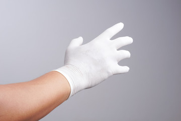 Hand wearing latex glove