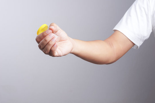 Hand holding empty urine plastic container