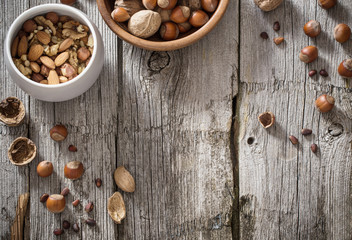 Fototapeta na wymiar Mixed nuts on old wooden background