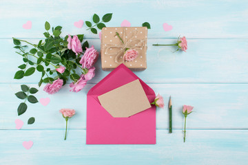 Roses with envelope, blank paper for greeting text and gift box