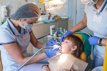 dentist and nurse curing childe teeth