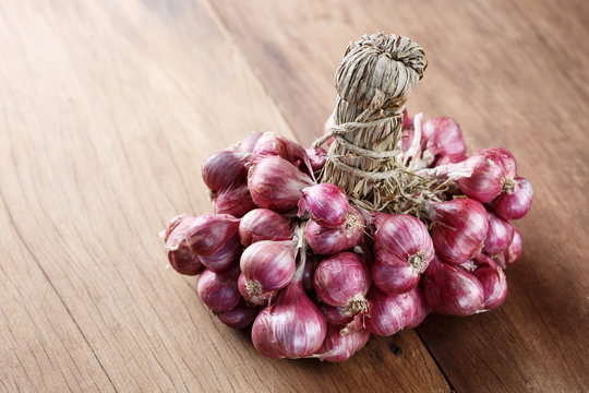 shallots onion on wood background front perspective view