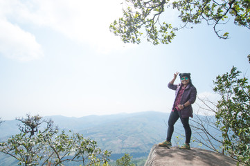 happy woman smile on top mountain with blue sky at sunny day, subject is soft focus