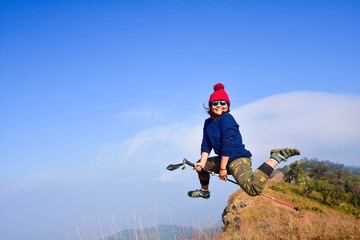 woman happy and jump on top mountain at sunny day Doi Mon Jong, Chaing Mai, Thailand. subject is blurred