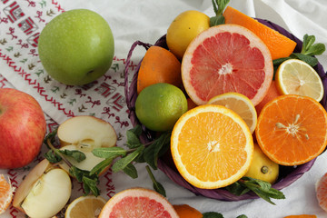 Fruit basket.sliced citrus fruits on a brown table, mixed color