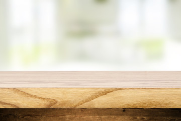 Top wooden table and in the blurry background interior of the kitchen with windows. Empty space to paste and mounting of different products.
