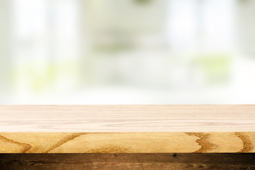 Top wooden table and in the blurry background interior of the kitchen with windows. Empty space to paste and mounting of different products.