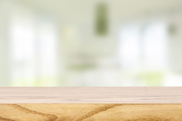 Top wooden table and in the blurry background interior of the kitchen with windows. Empty space to paste and mounting of different products.