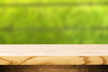 Top wooden table and in the background blurred plants as a theme spa. Empty space to paste and mounting of different products.