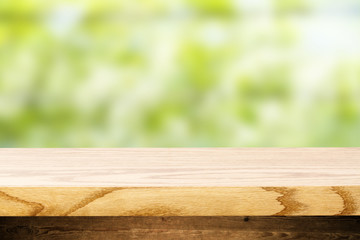 Top wooden table and in the background blurred plants as a theme spa. Empty space to paste and mounting of different products.