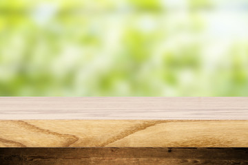 Top wooden table and in the background blurred plants as a theme spa. Empty space to paste and mounting of different products.